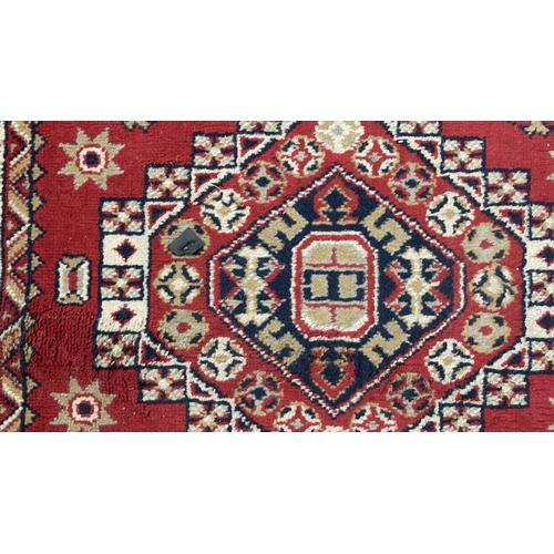 184 - A Persian style machine woven red ground geometric patterned hall runner - approx. 325cm x 80cm