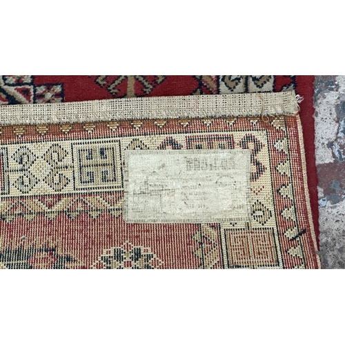 184 - A Persian style machine woven red ground geometric patterned hall runner - approx. 325cm x 80cm