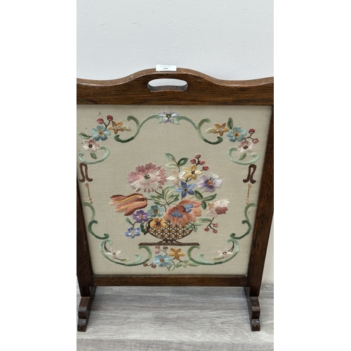 185 - An early 20th century oak framed floral tapestry fire screen - approx. 75cm high x 49cm wide x 16cm ... 