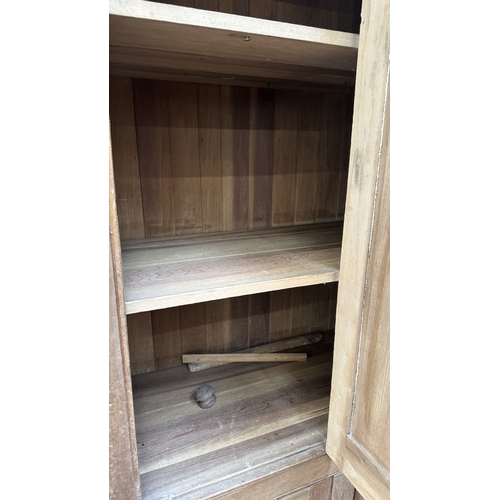197 - A 19th century stripped hardwood housekeeper's cupboard - approx. 213cm high x 140cm wide x 47cm dee... 