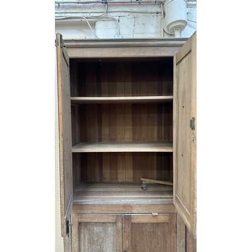 197 - A 19th century stripped hardwood housekeeper's cupboard - approx. 213cm high x 140cm wide x 47cm dee... 