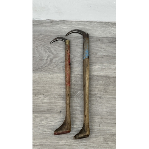 205 - Two early 20th century Japanese wood and iron tuna gaffs, signed to base - largest approx. 39cm long