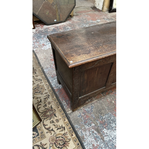 218 - An 18th century carved oak three panel coffer - approx. 62cm high x 113cm wide x 48cm deep