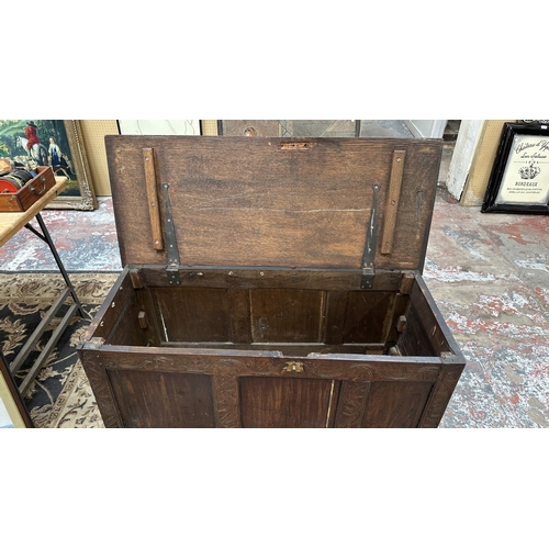 218 - An 18th century carved oak three panel coffer - approx. 62cm high x 113cm wide x 48cm deep