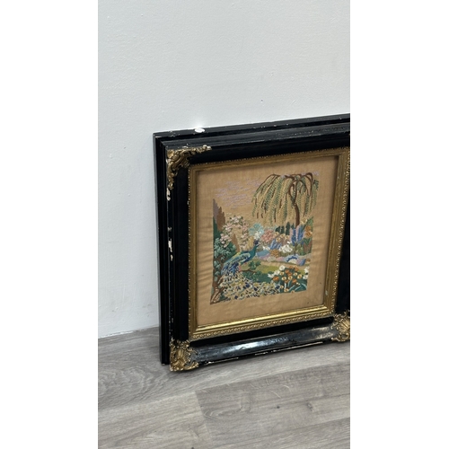 226 - A Victorian gilt and black lacquered framed embroidery depicting a peacock - approx. 54cm high x 47c... 