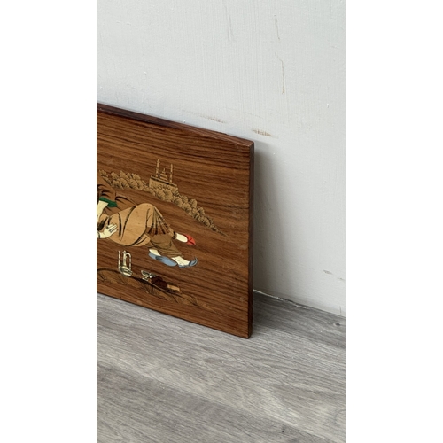 232 - An Indian marquetry inlaid hardwood wall plaque depicting couple - approx. 29.5cm high x 45cm wide