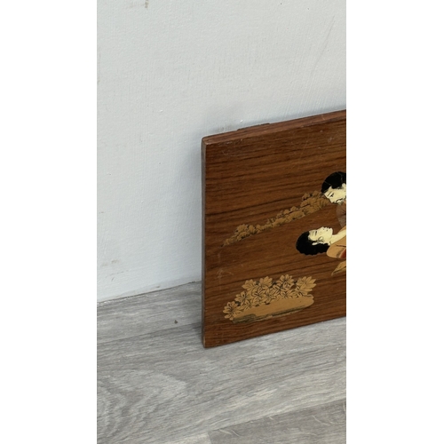232 - An Indian marquetry inlaid hardwood wall plaque depicting couple - approx. 29.5cm high x 45cm wide