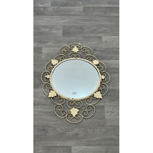 234 - Two metal framed wall mirrors with floral decoration, one white painted - approx. 75cm high x 54cm w... 