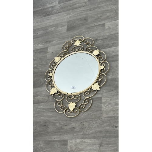 234 - Two metal framed wall mirrors with floral decoration, one white painted - approx. 75cm high x 54cm w... 