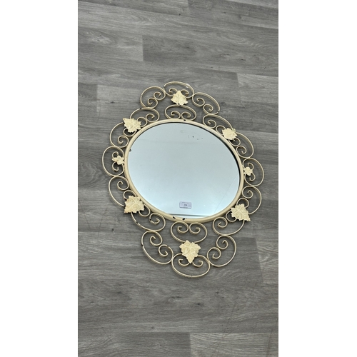 234 - Two metal framed wall mirrors with floral decoration, one white painted - approx. 75cm high x 54cm w... 