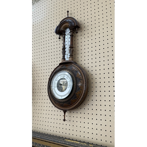 235 - A late 19th/early 20th century carved walnut framed aneroid barometer - approx. 56cm high x 23cm wid... 