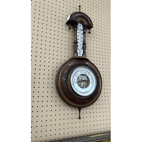235 - A late 19th/early 20th century carved walnut framed aneroid barometer - approx. 56cm high x 23cm wid... 