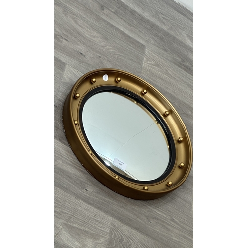239 - A mid 20th century Regency style gilt framed circular convex wall mirror bearing label to reverse 'A... 