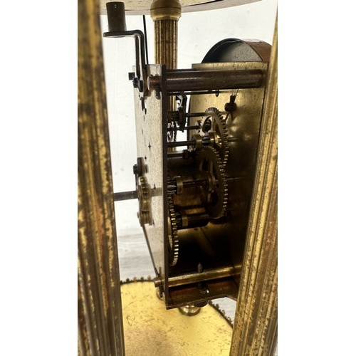 247 - A German brass 400-day torsion clock with glass dome, key, pendulum and B crescent moon logo to reve... 