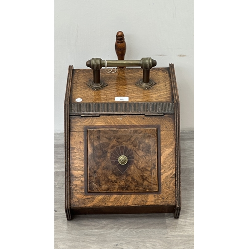 249 - A late 19th/early 20th century oak and walnut coal scuttle with brass handle and shovel - approx. 36... 