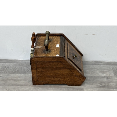 249 - A late 19th/early 20th century oak and walnut coal scuttle with brass handle and shovel - approx. 36... 