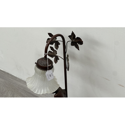 250 - An Art Nouveau style bronzed resin and metal figural table lamp with glass shade - approx. 56cm high
