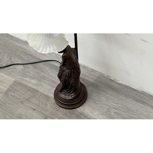 250 - An Art Nouveau style bronzed resin and metal figural table lamp with glass shade - approx. 56cm high