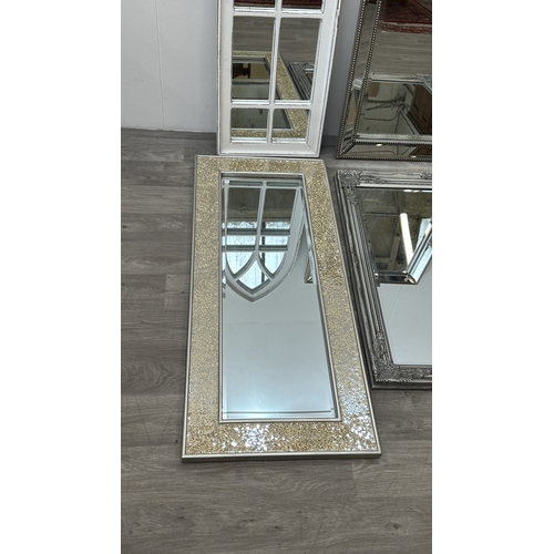 255 - Four modern framed wall mirrors, one white painted arched, one silver painted and bevelled, one Fren... 