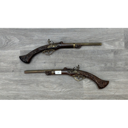 256 - A pair of 18th century style carved wooden and brass ornamental flintlock pistols - approx. 52cm lon... 