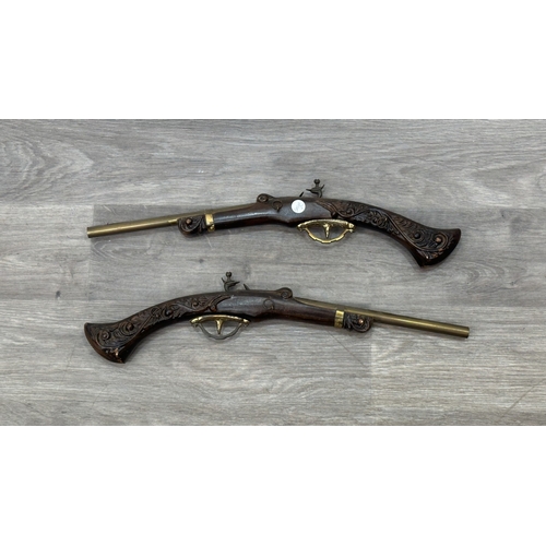 256 - A pair of 18th century style carved wooden and brass ornamental flintlock pistols - approx. 52cm lon... 