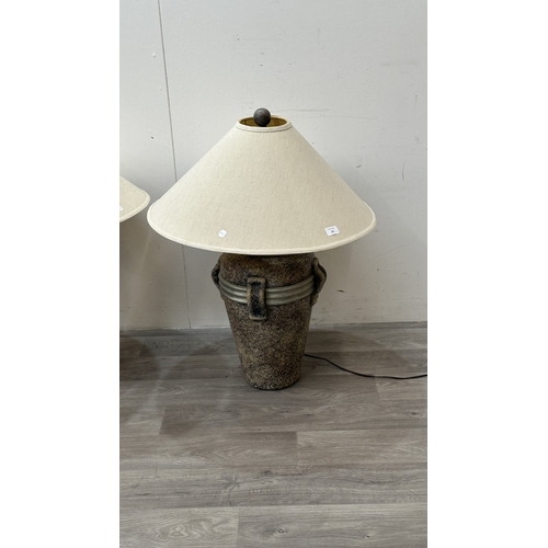 261 - A pair of stone effect plaster urn shaped table lamps with shades - approx. 80cm high