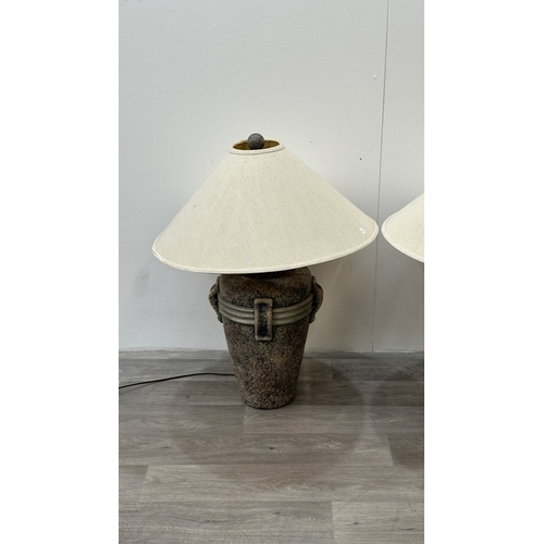 261 - A pair of stone effect plaster urn shaped table lamps with shades - approx. 80cm high