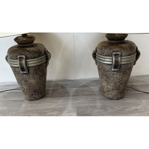 261 - A pair of stone effect plaster urn shaped table lamps with shades - approx. 80cm high