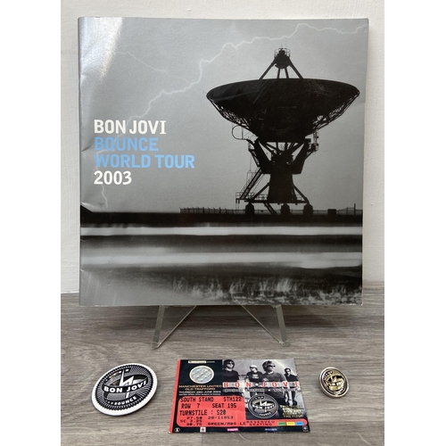 103 - An official Bon Jovi 'Bounce' 2003 UK tour programme together with two badges and a ticket for Manch... 