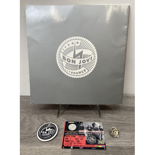 103 - An official Bon Jovi 'Bounce' 2003 UK tour programme together with two badges and a ticket for Manch... 