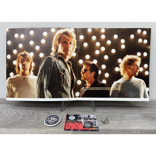 103 - An official Bon Jovi 'Bounce' 2003 UK tour programme together with two badges and a ticket for Manch... 