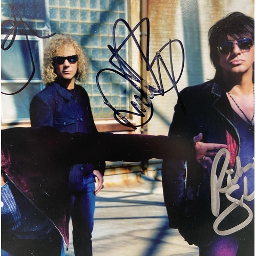 114 - A signed colour photograph of Bon Jovi features hand-signed autographs from band members Jon Bon Jov... 