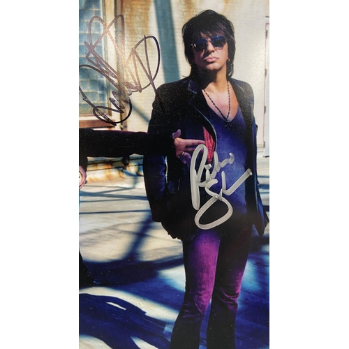 114 - A signed colour photograph of Bon Jovi features hand-signed autographs from band members Jon Bon Jov... 