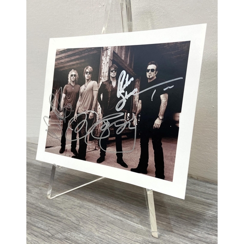 115 - A signed photograph of Bon Jovi features hand-signed autographs from band members Jon Bon Jovi, Rich... 