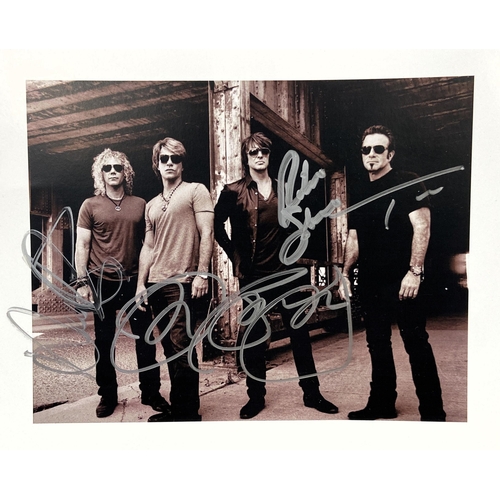 115 - A signed photograph of Bon Jovi features hand-signed autographs from band members Jon Bon Jovi, Rich... 