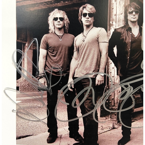 115 - A signed photograph of Bon Jovi features hand-signed autographs from band members Jon Bon Jovi, Rich... 