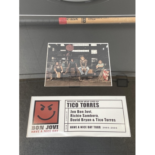 3 - A Bon Jovi framed memorabilia display featuring an official drumhead and drumstick used by Tico Torr... 