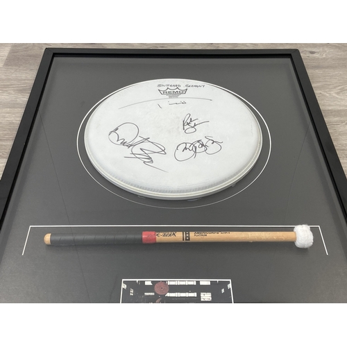 3 - A Bon Jovi framed memorabilia display featuring an official drumhead and drumstick used by Tico Torr... 