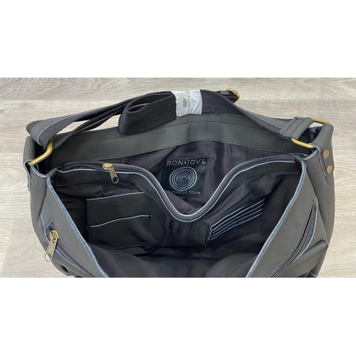 63 - A Bon Jovi 'The Circle Tour' black leather messenger bag was only given out to VIP ticket holders; i... 