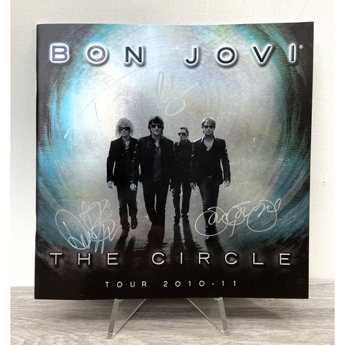68 - A signed tour programme, Bon Jovi's 'The Circle Tour 2010-2011,' features hand-signed autographs fro... 