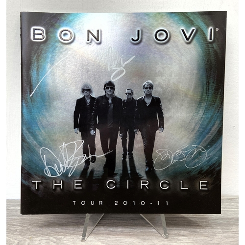 69 - A signed tour programme, Bon Jovi's 'The Circle Tour 2010-2011,' features hand-signed autographs fro... 