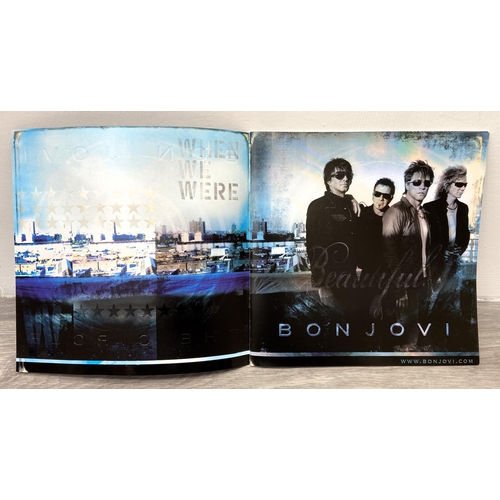 69 - A signed tour programme, Bon Jovi's 'The Circle Tour 2010-2011,' features hand-signed autographs fro... 