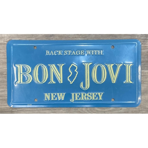 91 - Two Bon Jovi New Jersey-themed novelty license plates, one white with 