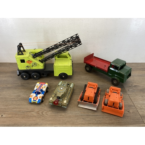 587 - A box containing six toy vehicles to include tinplate Crusader tank - made in Great Britain, Porsche... 