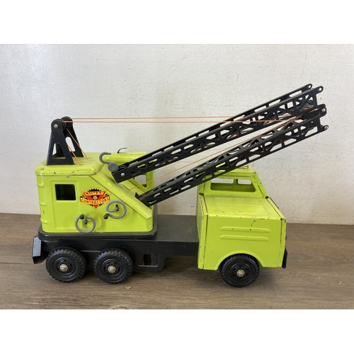 587 - A box containing six toy vehicles to include tinplate Crusader tank - made in Great Britain, Porsche... 