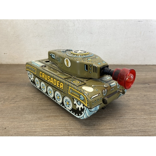 587 - A box containing six toy vehicles to include tinplate Crusader tank - made in Great Britain, Porsche... 