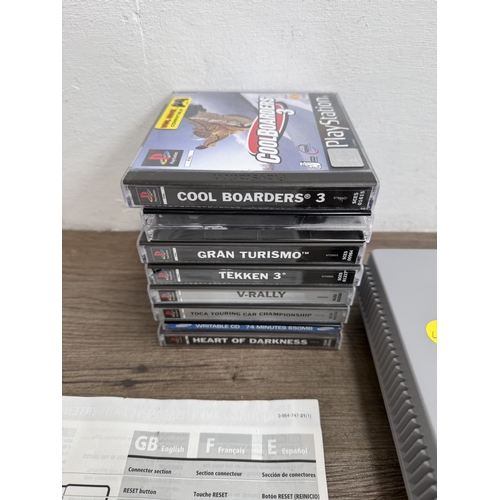 A Sony PlayStation SCPH-7502 games console with two controllers, cables ...