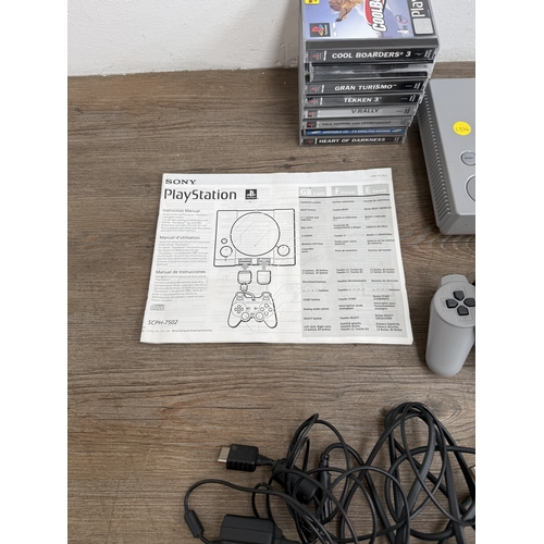 A Sony PlayStation SCPH-7502 games console with two controllers, cables ...