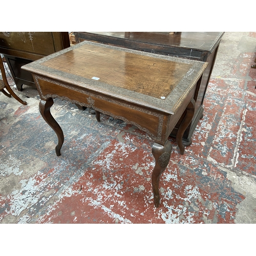 246 - A late 19th/early 20th century carved mahogany writing table with foliate design and cabriole suppor... 