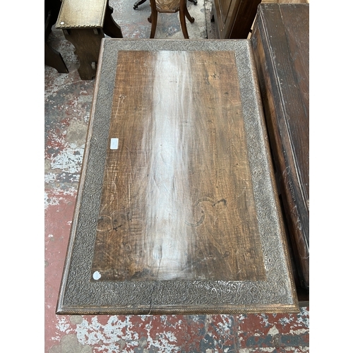 246 - A late 19th/early 20th century carved mahogany writing table with foliate design and cabriole suppor... 